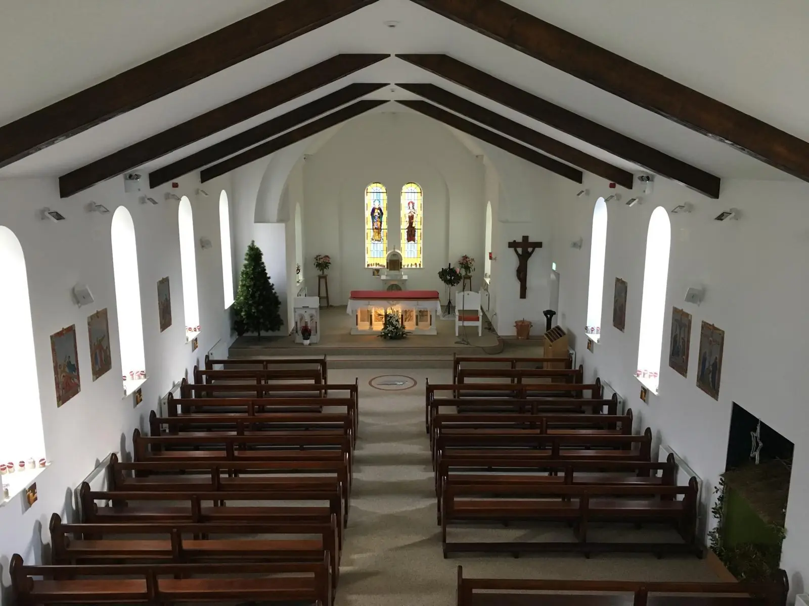 Completed church interior with timber pews and exposed beams