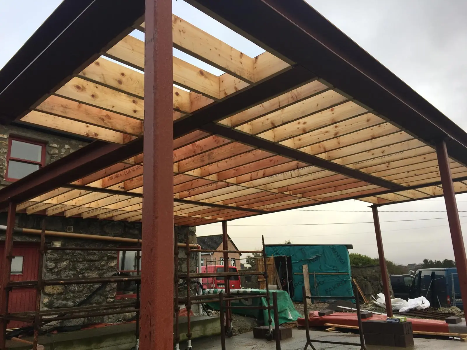 Structural timber and steel work during a construction project